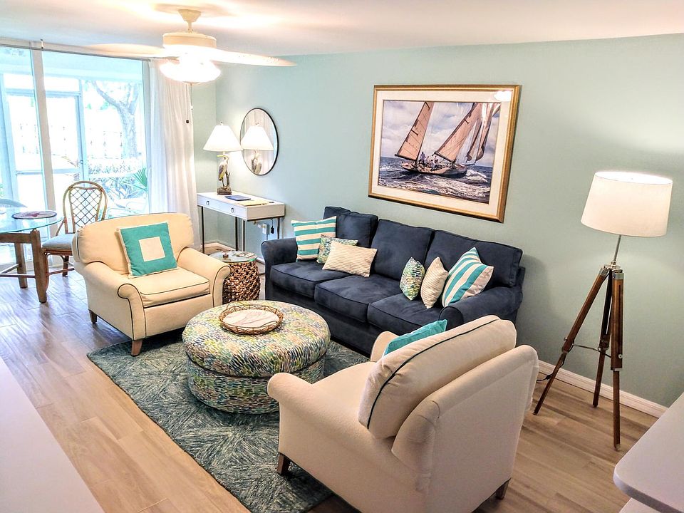 Living room with work desk, dining table and TV console/ storage.