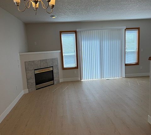 great room with sliding glass door to fenced shared back yard