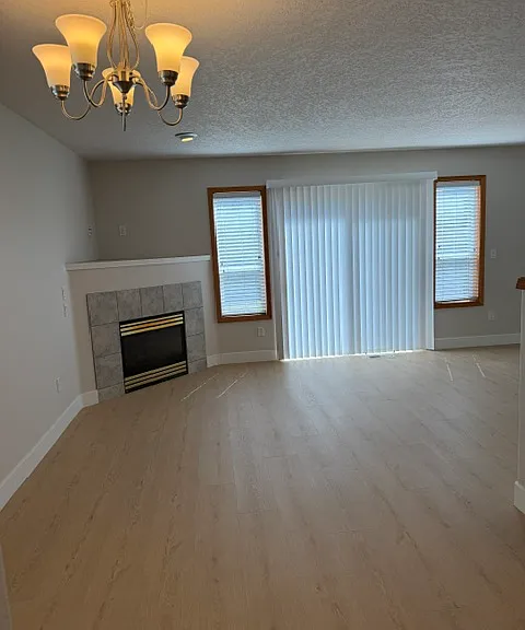 great room with sliding glass door to fenced shared back yard