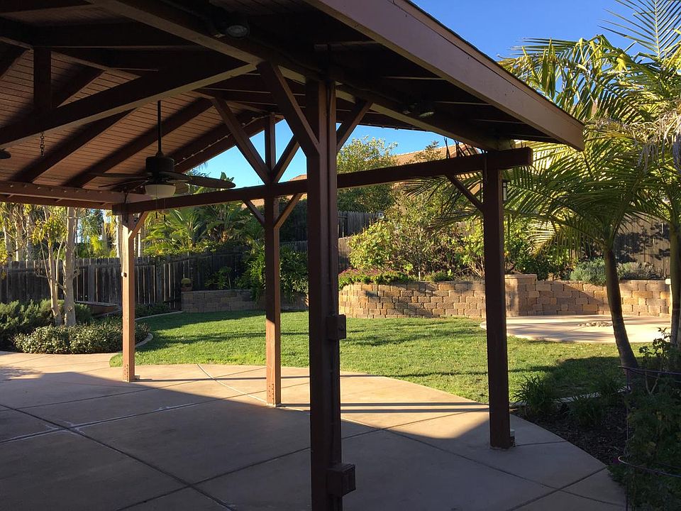 Fully covered patio and quaint backyard