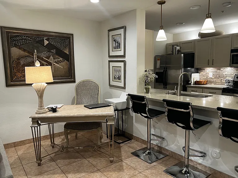 Office area with bar seating and down lighting over bar area