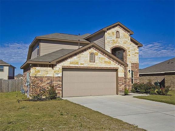 Front of home with landscaping and 7 zone sprinkler system