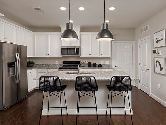 Model Representation - Stunning Kitchen with White Cabinetry and Stainless Steel Appliances