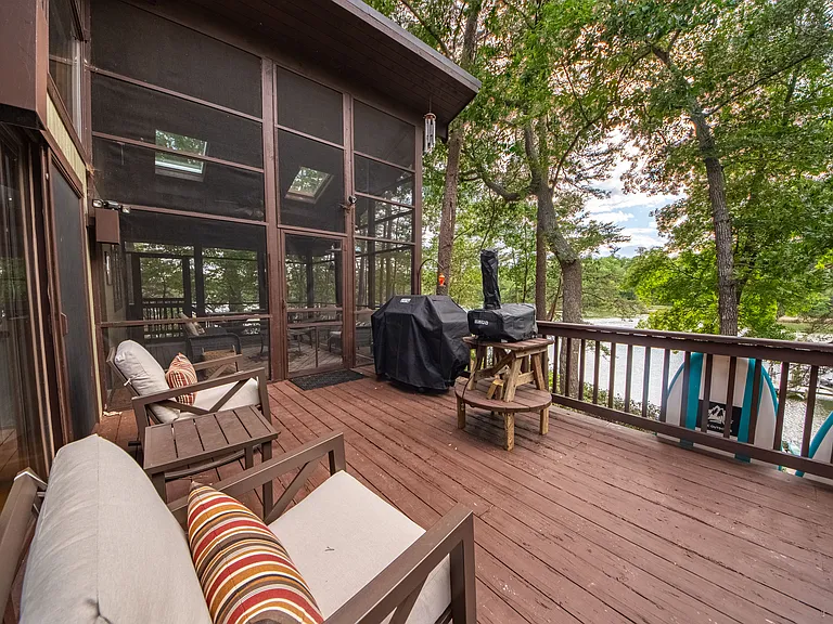 Deck and screened porch with views of water front.