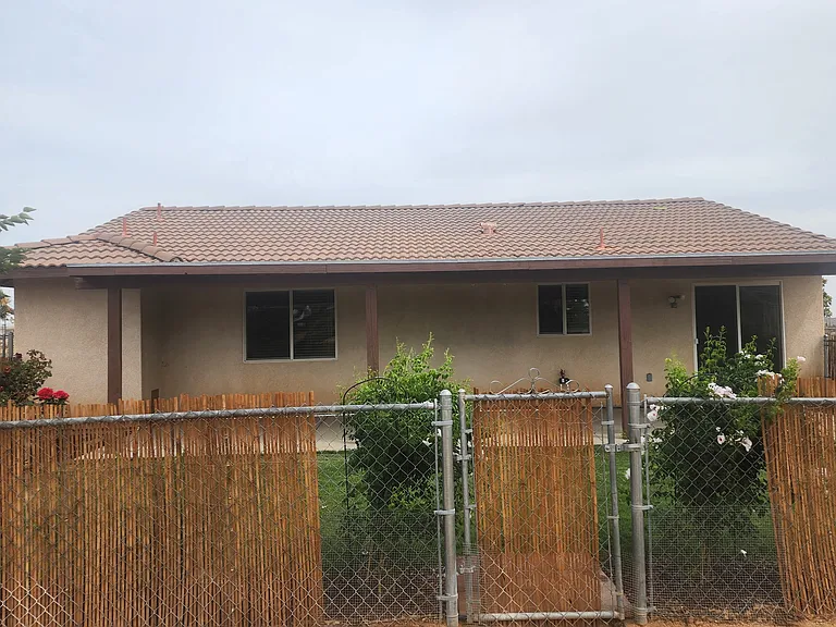 Back yard covered patio, with separately fenced area, lush lawn and landscaping