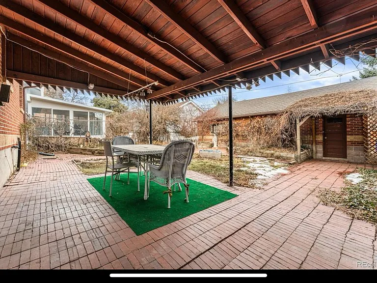 View of covered patio from the winter before the privacy fence was installed