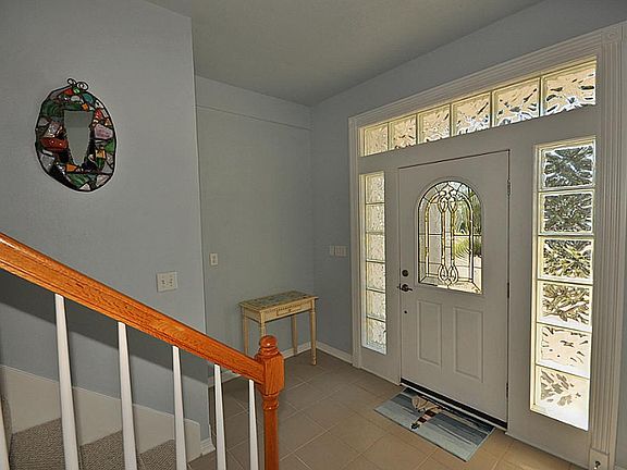 Tiled ground floor entrance with glass block surrounding the door.