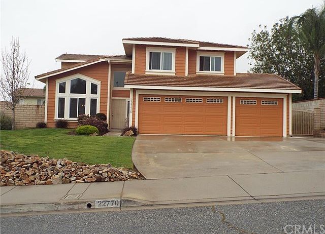 Street view of home.  All landscape in front is new with water saving decorative bark