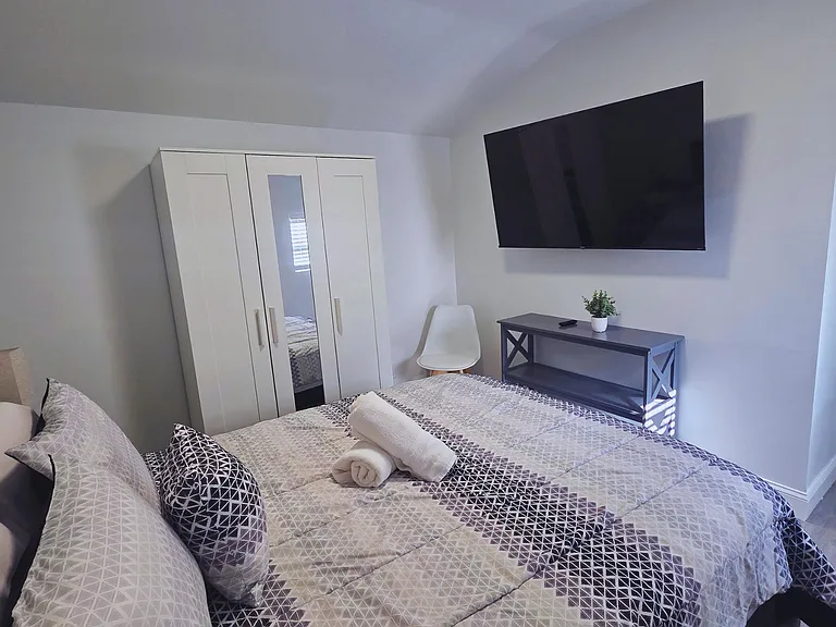Bedroom with Smart TV, bright space, and window for natural light