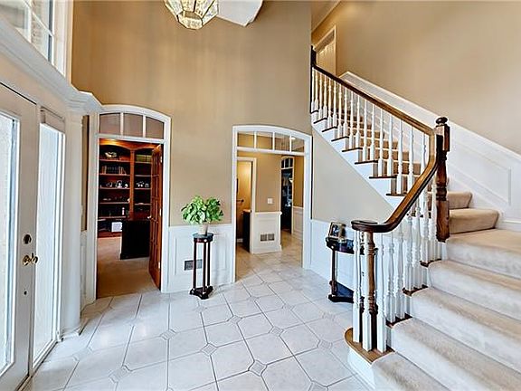Two story entry and arched transoms.