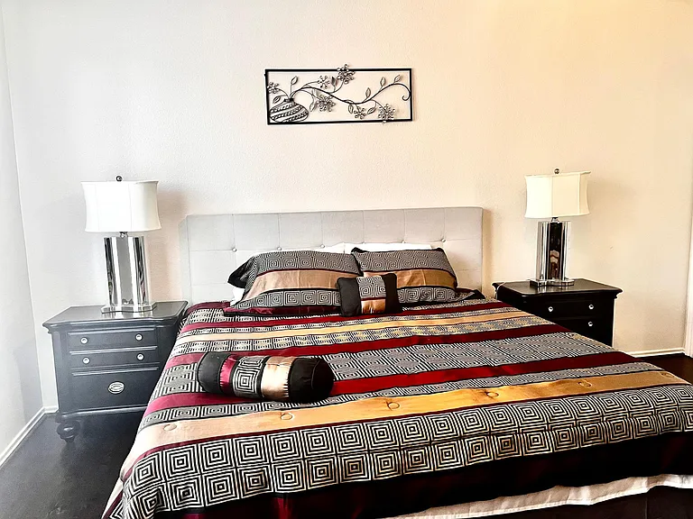 Bed room 1(Master bed room-down stairs)-King bed,night stand,dresser,mirror,work desk,chair