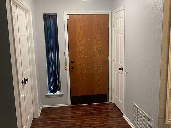 Front Entry way with spacious closet. French doors open into secondary bedroom which can also be used as home office.
