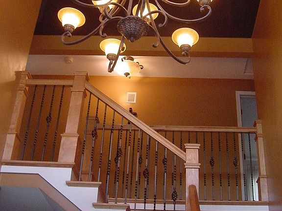 Gorgeous hardwood staircase and travertine floors upon entry.
