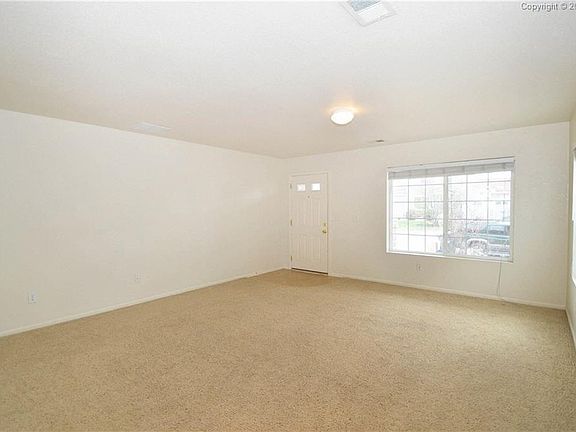 Spacious living room and front entry.