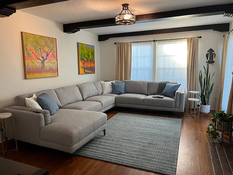 Sunny living room with original wood beams