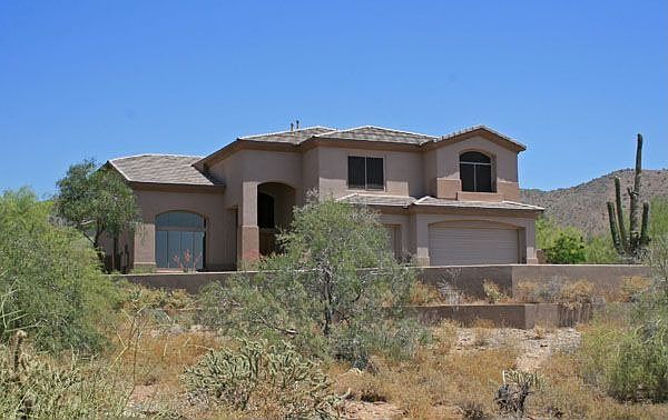 Front of home, private lot surrounded by wash on all sides