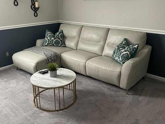 Upstairs family room. Leather sofa chase and marble table and sconces for sale as home will be rented empty unless renter wants to purchase furniture separately.