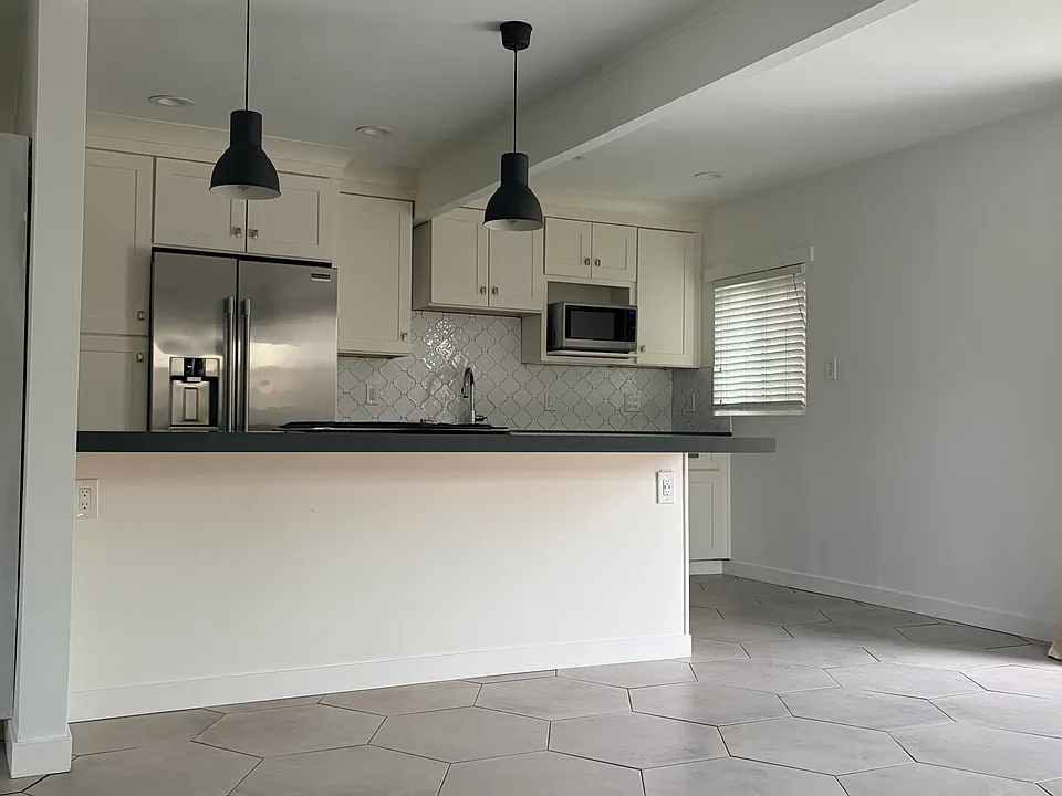 Open Kitchen with island that fits four chairs
