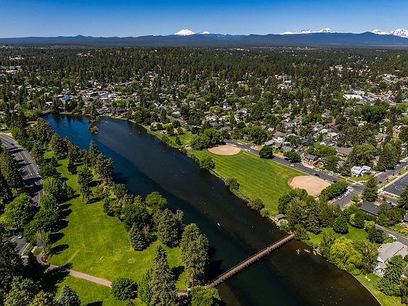 home is between the baseball diamonds looking east at the park and river: wooden walking bridge into old bend is steps away...