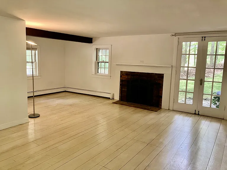 Large LR with French doors leading to a sitting area, 2 closets, working fireplace.