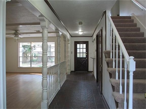 Enter in the home onto a tiled entry with a half bath nearby for guests.