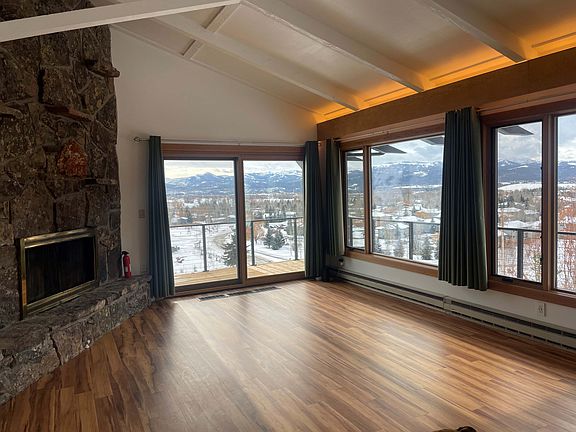 Living room and views to south / west (shows additional built-in double-sided fireplace)