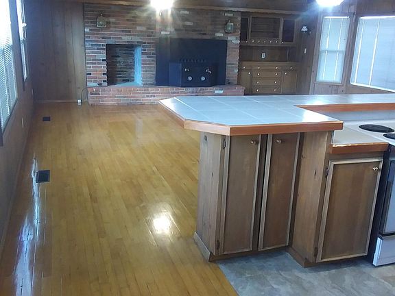 Spacious living room with dinning area on right side by back window. Newly resurfaced hardwood floors.