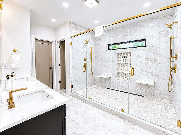 Spa-inspired primary bathroom in the Edgewood Suite featuring luxury, large walk-in shower with rainfall & dual shower heads, plush linens, & premium Apotheke bath products. Designed to help you unwind & indulge in a true boutique hotel experience.