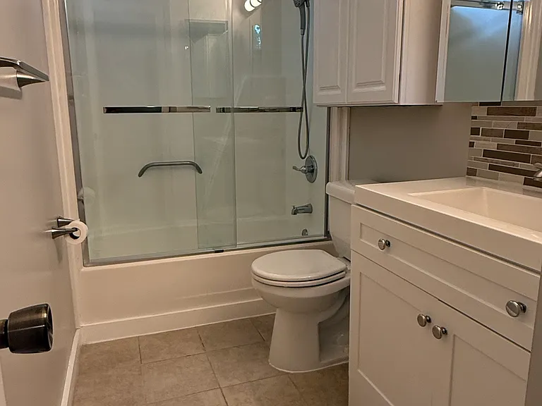 Upstairs bathroom full view shower and sink with brushed nickel
Plenty of storage for towels