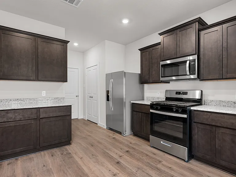 The kitchen has beautiful wood cabinetry.