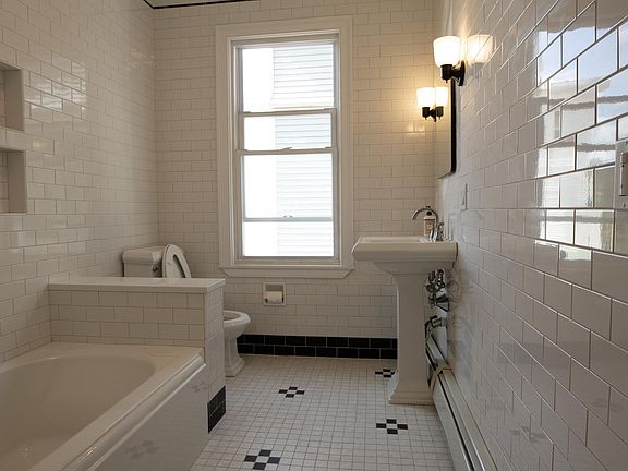 Stunning floor to ceiling subway tiled bathroom