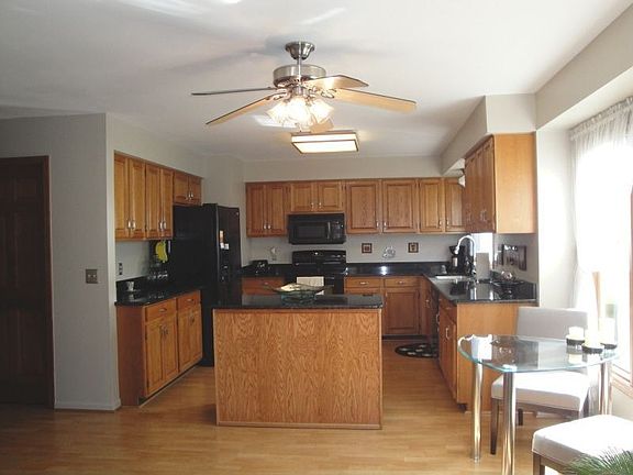 Large, bright kitchen area with granite counters