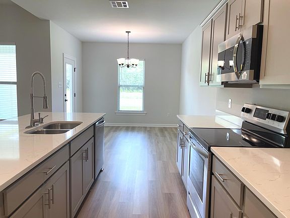 Dining area adjacent to kitchen with view of pond