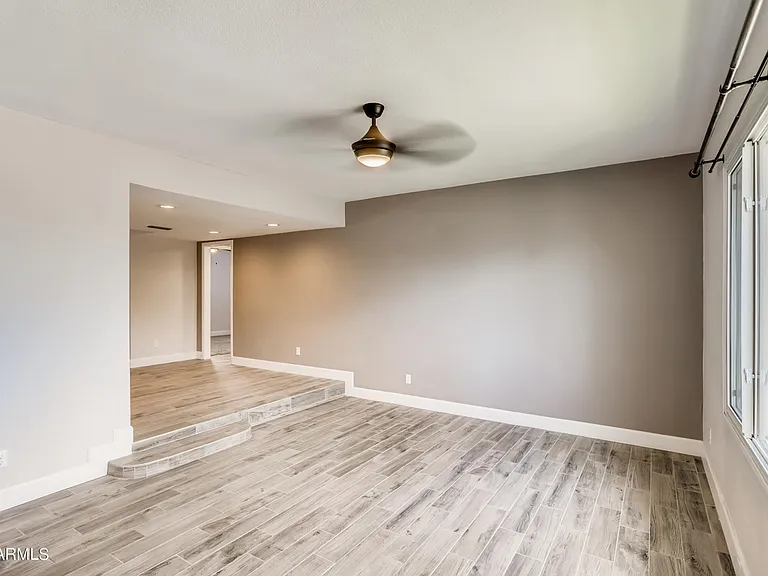 Large south-facing living room with high ceilings. Step up to the dining area.