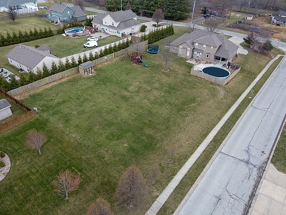 Beautiful, flat 1 acre lot with access from the side street, perfect to build that outbuilding, basketball court, or even upgrade to an in-ground pool. NO HOA!!