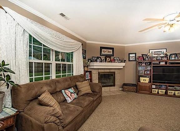 Wood burning fireplace in living room and big windows looking into the back yard!