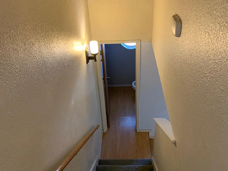 Staircase to upper bedrooms and half bath downstairs.