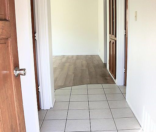 Entrance, area for entry table, and large coat closet for shoes and coats behind door.