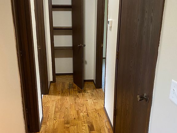 Hardwood floors continue through the hallway.