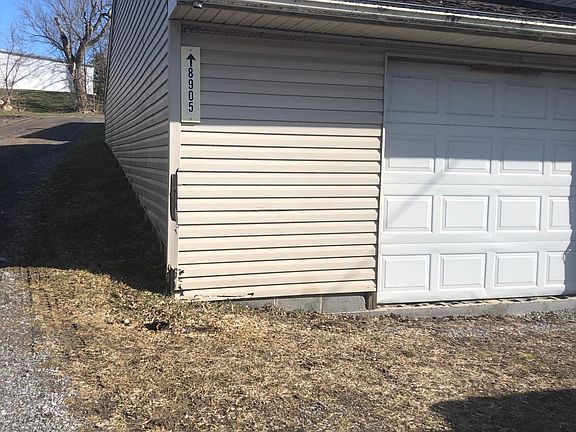 From the road. The driveway is along the left of the building.