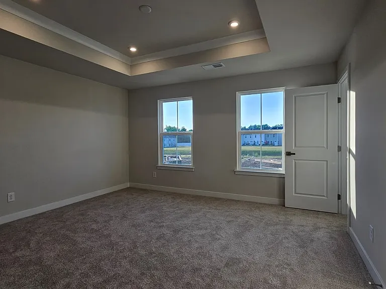 Master bedroom with Tray ceilings; Ample sunlight with three windows