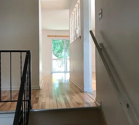 Front Entry is stairs to living room, back deck through sliding doors, Kitchen, bathroom, & 2 Bedrooms --- All Hardwood floors