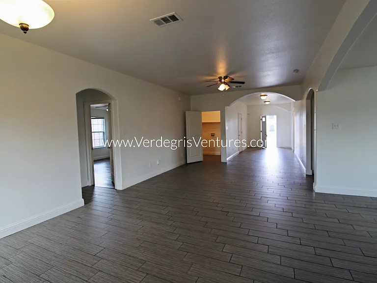 A spacious, open_concept layout connecting the kitchen, living, and dining areas.