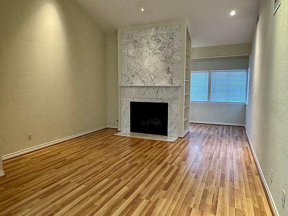 Living Room with vaulted ceiling and custom marble fireplace.