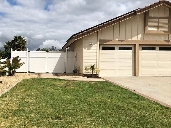 Double gate to concrete side yard area.