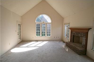 The great room includes a Palladium window and door accessing the screened porch plus a woodburning fireplace.