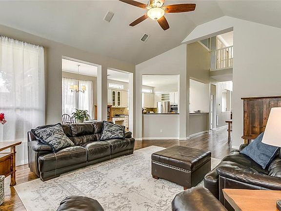 Gorgeous Family Room boasts a stunning fireplace & gorgeous natural light in this open floorplan.