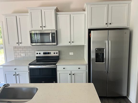 Kitchen appliances in near-mint condition: Refrigerator, Dishwasher, Microwave, Stove, and Oven.