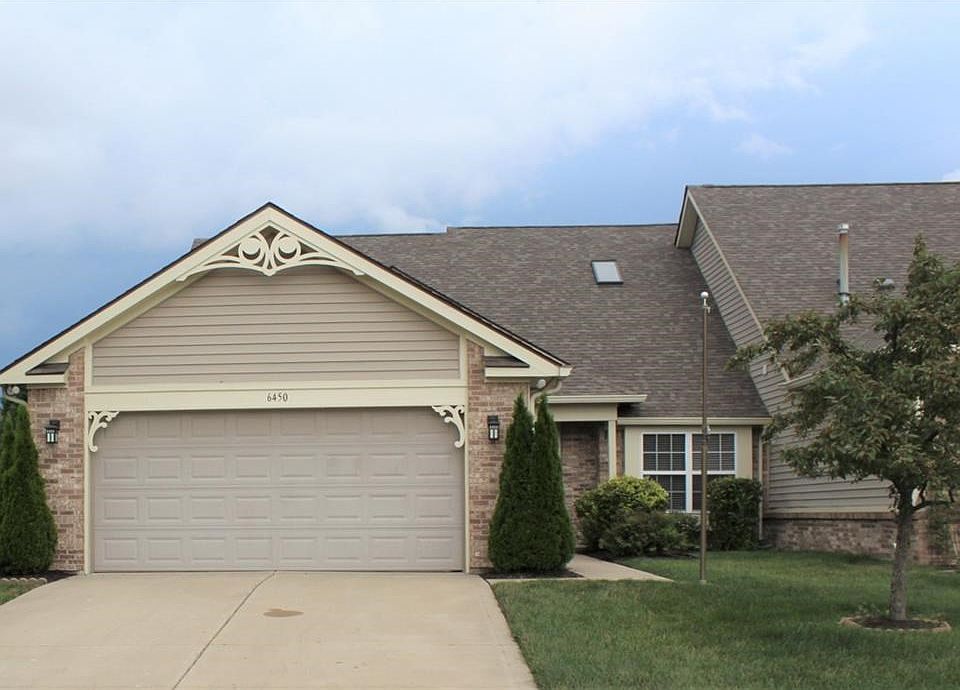 Front of condo with an over sized two car attached garage.