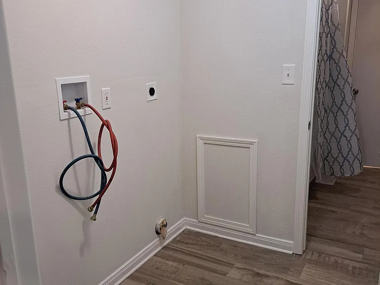 Laundry room with brand new on demand water heater.